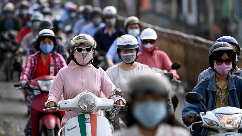 Morning commuters wear face masks in Hanoi. AFP