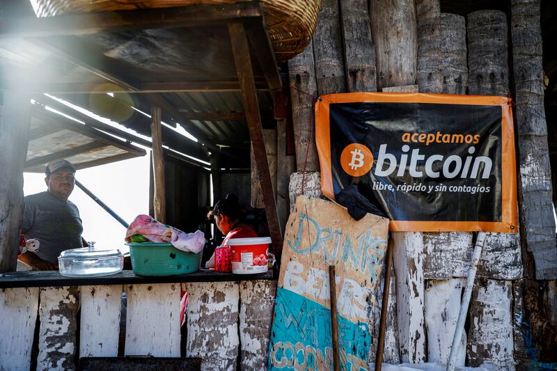 A banner that reads "We accept Bitcoin, free, fast and without contagion" is seen at a beach cafe on Punta Roca Beach in La Libertad, El Salvador. Reuters