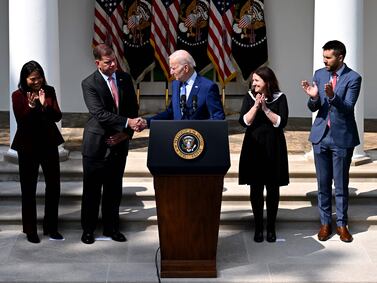 US President Joe Biden shakes hands with US Secretary of Labor Marty Walsh after speaking about the railway labor agreement in the Rose Garden of the White House in Washington, DC. AFP